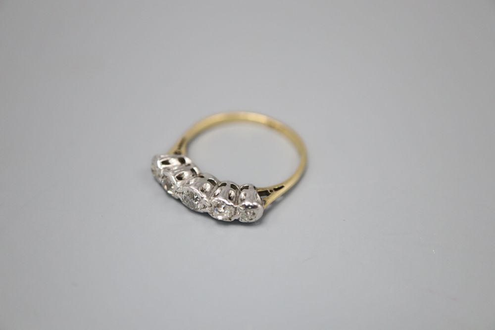 An 18ct and graduated illusion set five stone diamond half hoop ring, size L, gross 2.9 grams.